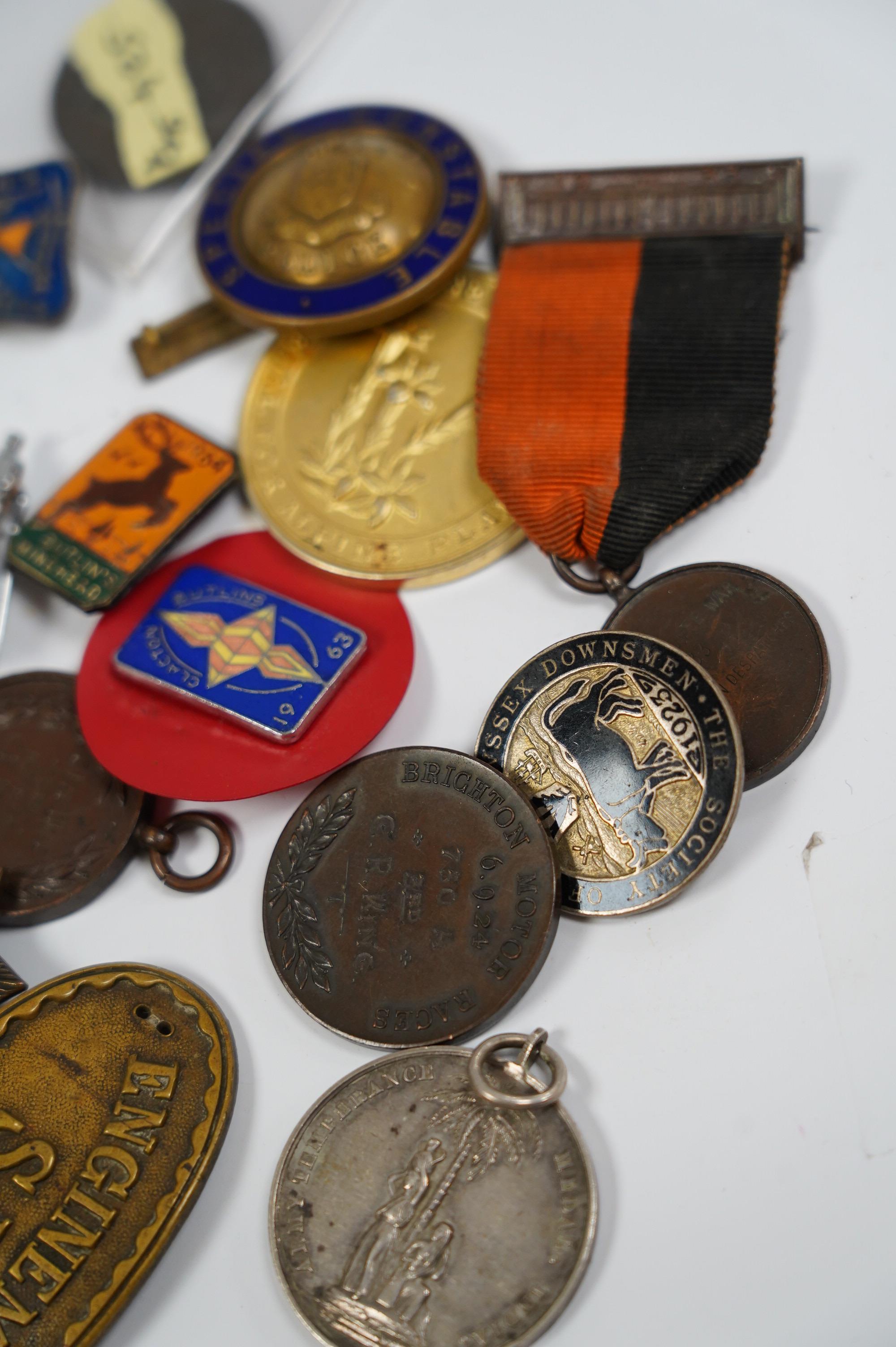 A group of assorted tokens, medallions and badges